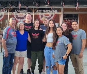 The NEST team standing together inside the venue